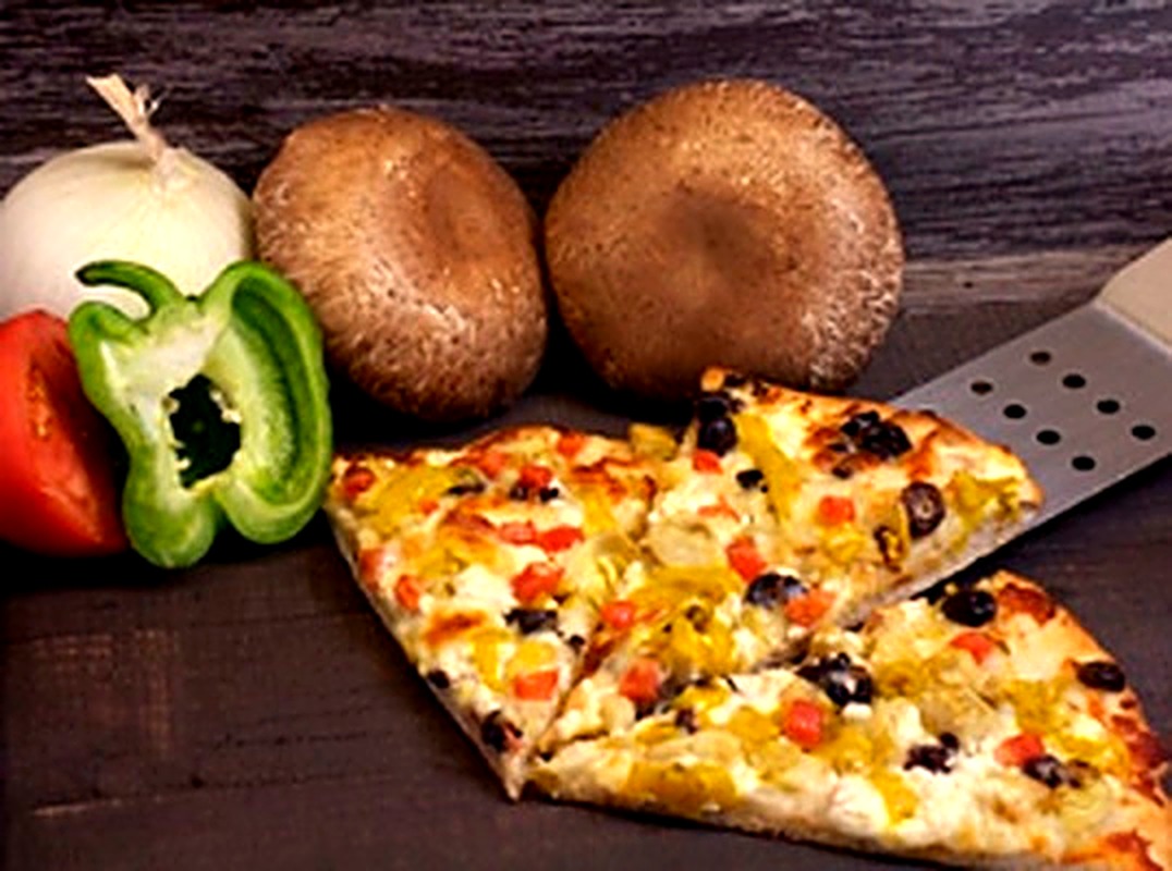 Veggie pizza slices with peppers, mushrooms and olives