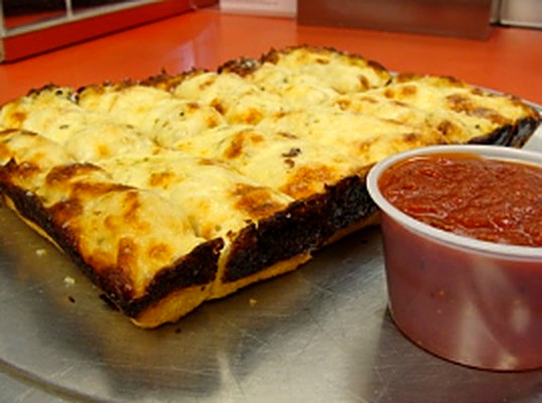 Cheese bread squares with a side of marinara